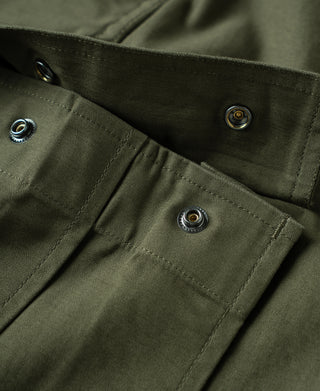 Olive cargo pants close-up of metal snaps on pocket flap and waistband