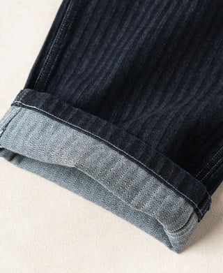 Indigo denim cuffs with chevron-pattern lining detail at the ankle hem