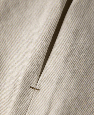 Natural twill jacket side seam with small bar tack detail
