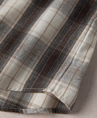 Plaid shirt sleeve cuff detail with dark and beige stripes