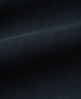 Navy herringbone fabric texture close-up on deck pants
