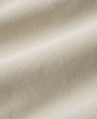 White corduroy texture close-up with fine vertical ridges