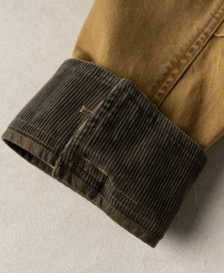 Jacket sleeve cuff turned back to show dark ribbed lining