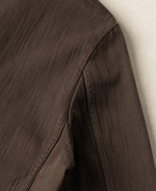 Brown herringbone blazer side panel seam and underarm lining edge