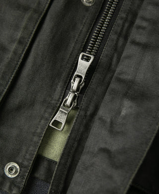 Black olive field jacket zipper with metal pull and snap-front placket detail
