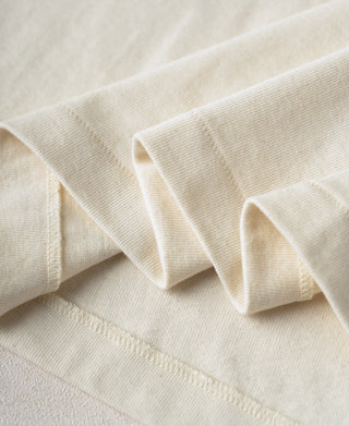 Cream cotton henley cuff detail with layered ribbed trim and topstitching