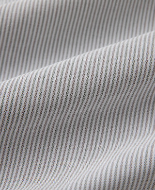 Oxford shirt fabric drape close-up, blue-and-white vertical pinstripe weave.