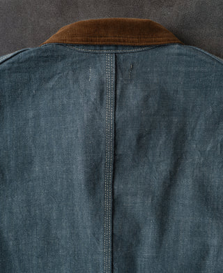 Back view of sage blue denim barn jacket with brown corduroy collar and center seam