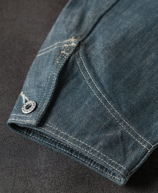 Sage blue denim jacket cuff with snap button and detailed contrast stitching
