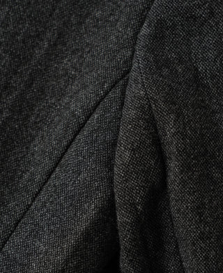 Gray wool suit jacket fabric with folded drape and satin lining edge