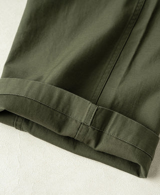 Olive cargo pants cuff close-up with elastic band and stitched hem