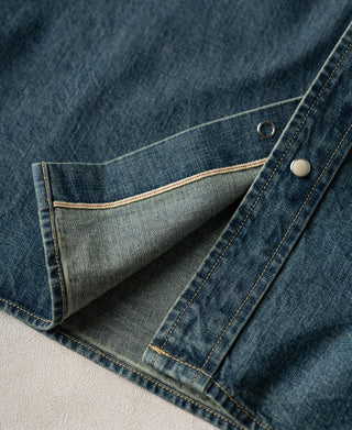Washed denim shirt pocket lining peeking through with snap button detail