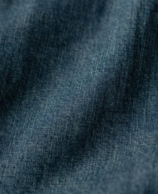 Washed denim fabric texture close-up with subtle speckled finish