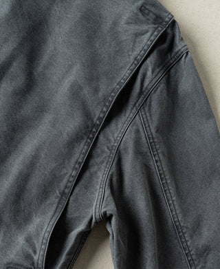 Gray-blue canvas jacket side with reinforced panel seams