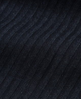 Indigo herringbone denim pants fabric close-up