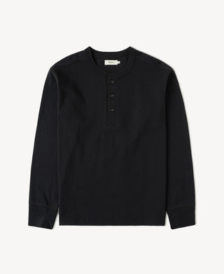 Front view of a black 1930s inspired loopwheel cotton Henley shirt with three-button placket.