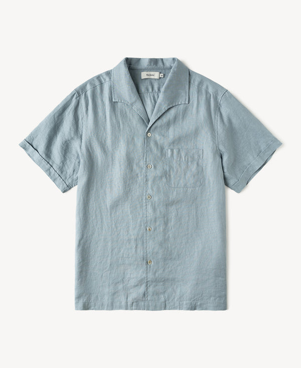Light blue linen short-sleeve shirt with open collar and button front, chest pocket.