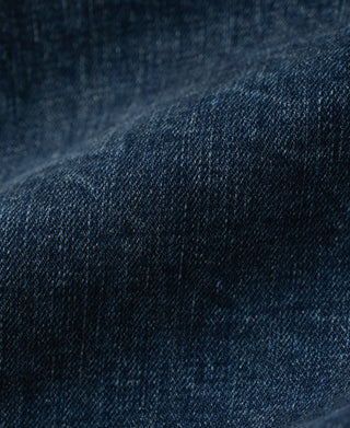 Close-up of indigo denim fabric texture and subtle heathered wash