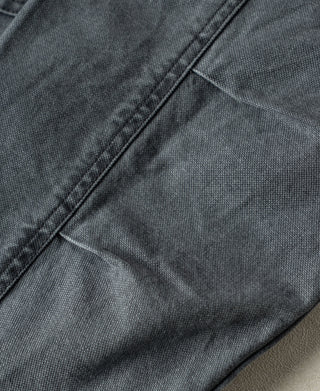 Gray-blue canvas jacket seam and button placket close-up