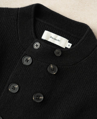 Black knit cardigan neckline with front buttons and interior label at collar