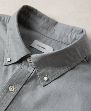Gray button-down collar with white buttons and neck label