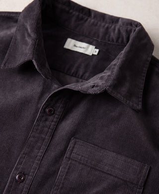 Purple corduroy button-up work shirt with chest pocket and dark buttons at placket