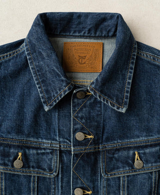 Indigo denim rider jacket with wide collar, button front, and chest flap pockets