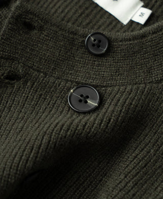 Olive knit cardigan close-up of round buttons and textured fabric