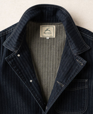 Indigo denim work jacket interior view with triangular lining and brand label