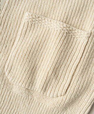 Close-up of the cardigan's patch pocket and textured natural cotton rib knit
