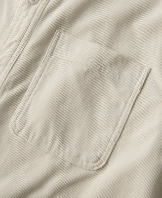 White corduroy chest pocket with flap and stitched edges