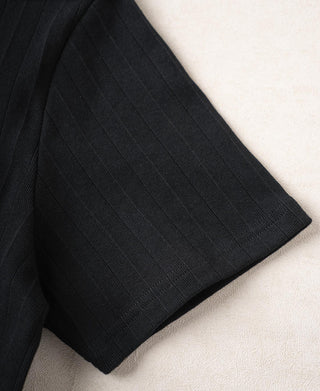 Hem corner close-up of vintage black ribbed cotton T-shirt with structured knit.