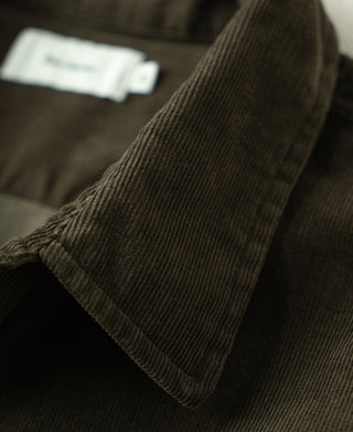 Corduroy shirt cuff and sleeve seam detail in dark green