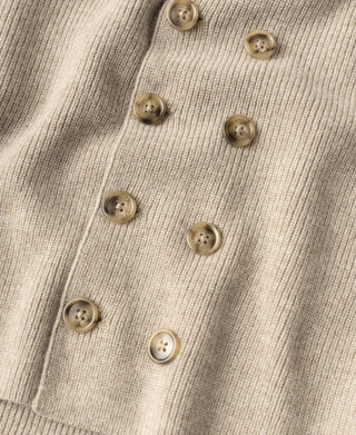 Ecru double-breasted knit cardigan with gold-tone buttons along the placket.