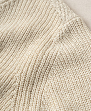 Cotton sweater close-up showing ribbed and seed-stitch knit textures