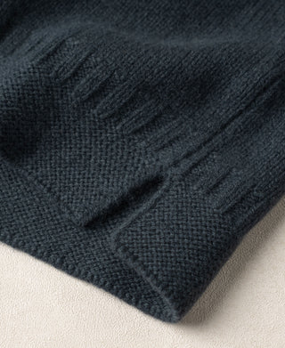 Dark blue wool sweater hem with textured knit and ribbed edge