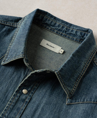 Washed denim western shirt with button front, pointed collar, and contrast topstitching