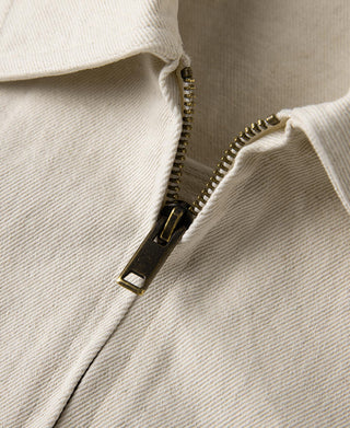 Natural twill jacket front zipper with metal pull and visible zipper teeth