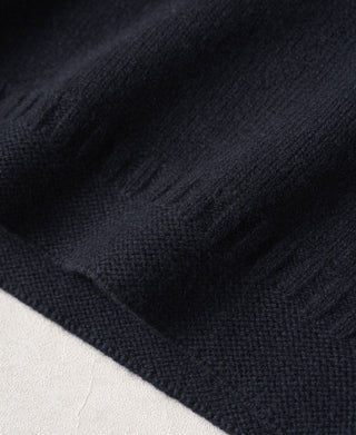 Close-up of the sweater's textured navy wool knit and hem