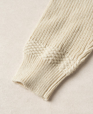 Close-up of the cardigan's ribbed cuff and textured cotton sleeve