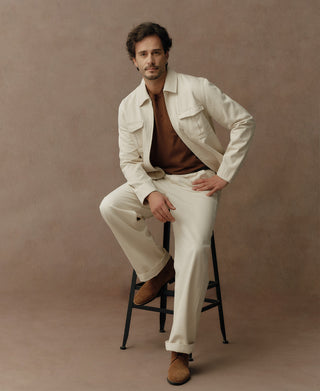 Natural twill jacket shown open with a cropped waist-length cut and flap chest pockets