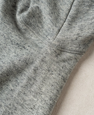 Heather gray sweatshirt sleeve and V-shaped yoke seam detail