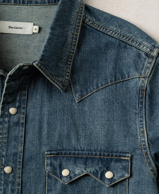 Washed denim western shirt showing chest yoke, button placket, and western yoke pockets