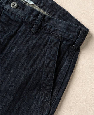 Indigo herringbone denim work pants with side button pocket and belt loops