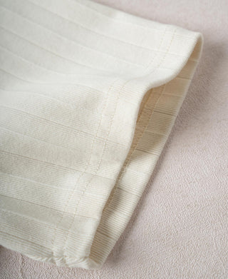 Oatmeal ribbed cotton T-shirt sleeve hem and cuff close-up with stitching