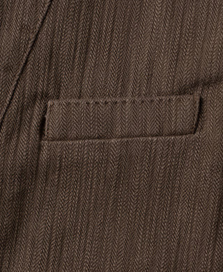 Brown herringbone waistcoat chest pocket with stitched flap and textured fabric