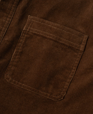 Brown corduroy chest pocket with stitched edges on work shirt