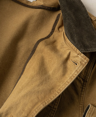 Canvas jacket lapel showing dark collar underside and stitched buttonhole