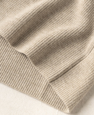 Ecru knit cardigan hem and ribbed cuffs with textured knit finish.
