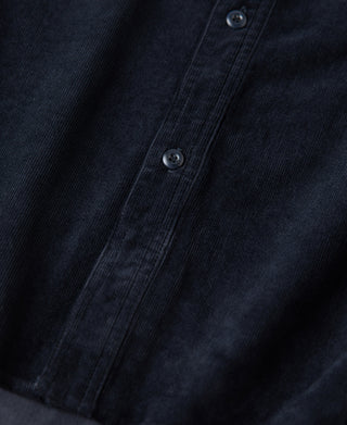 Indigo corduroy shirt button placket with two visible buttons